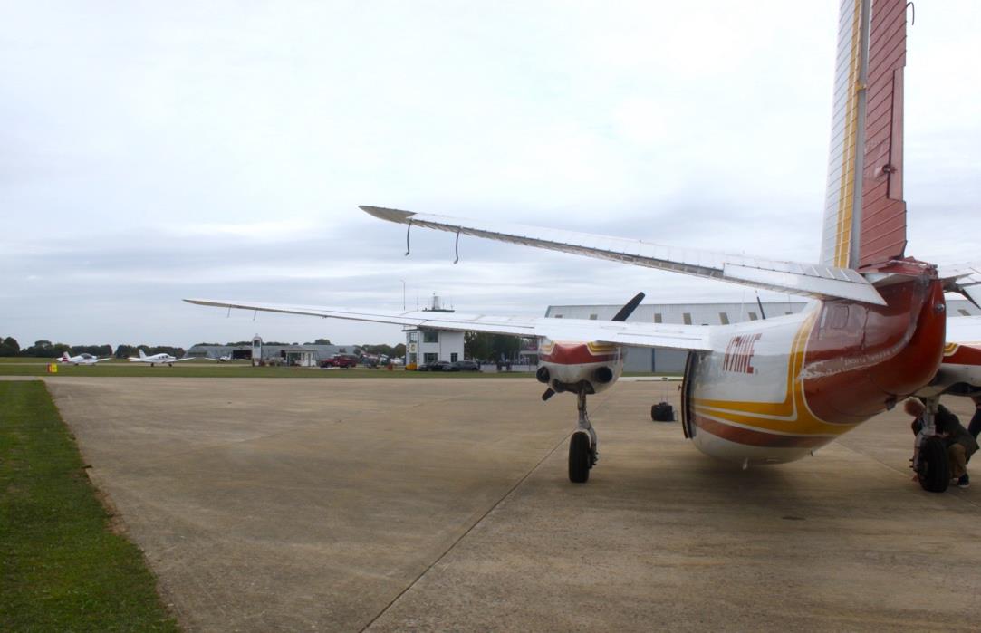 Rear view of Aero Commander 500 N711NE showing tail and wings on the tarmac