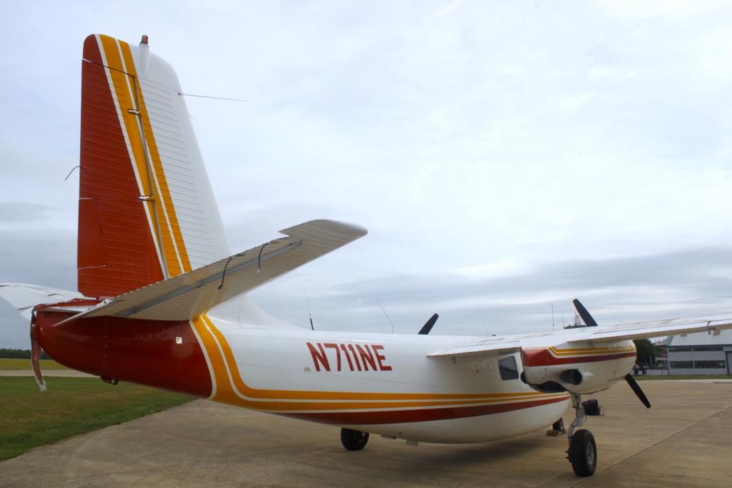 Rear view of Aero Commander 500 N711NE showing tail and vertical stabilizer