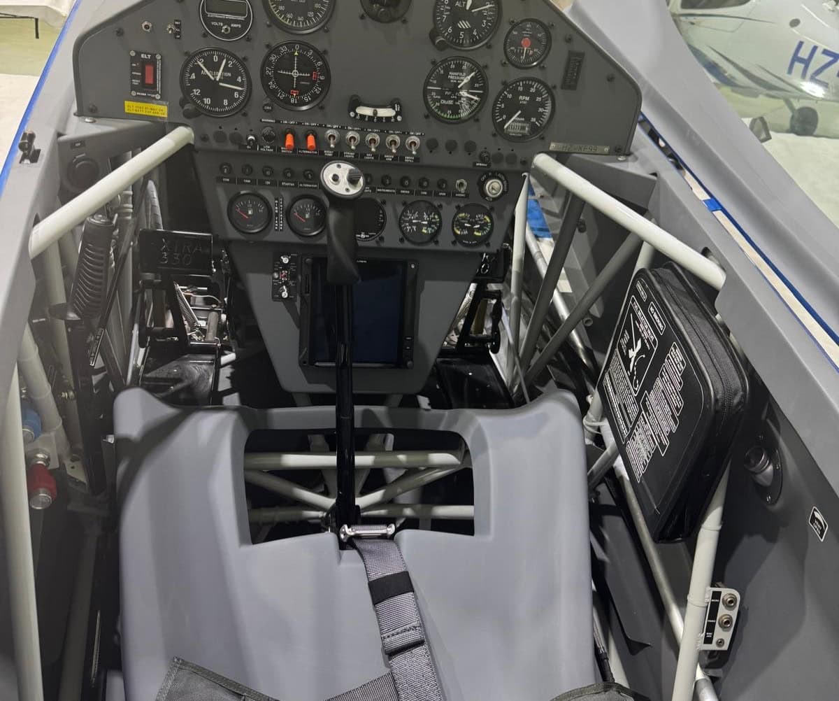 Pilot seat and cockpit controls of Extra 330LX HZ-XF98 showcasing interior layout
